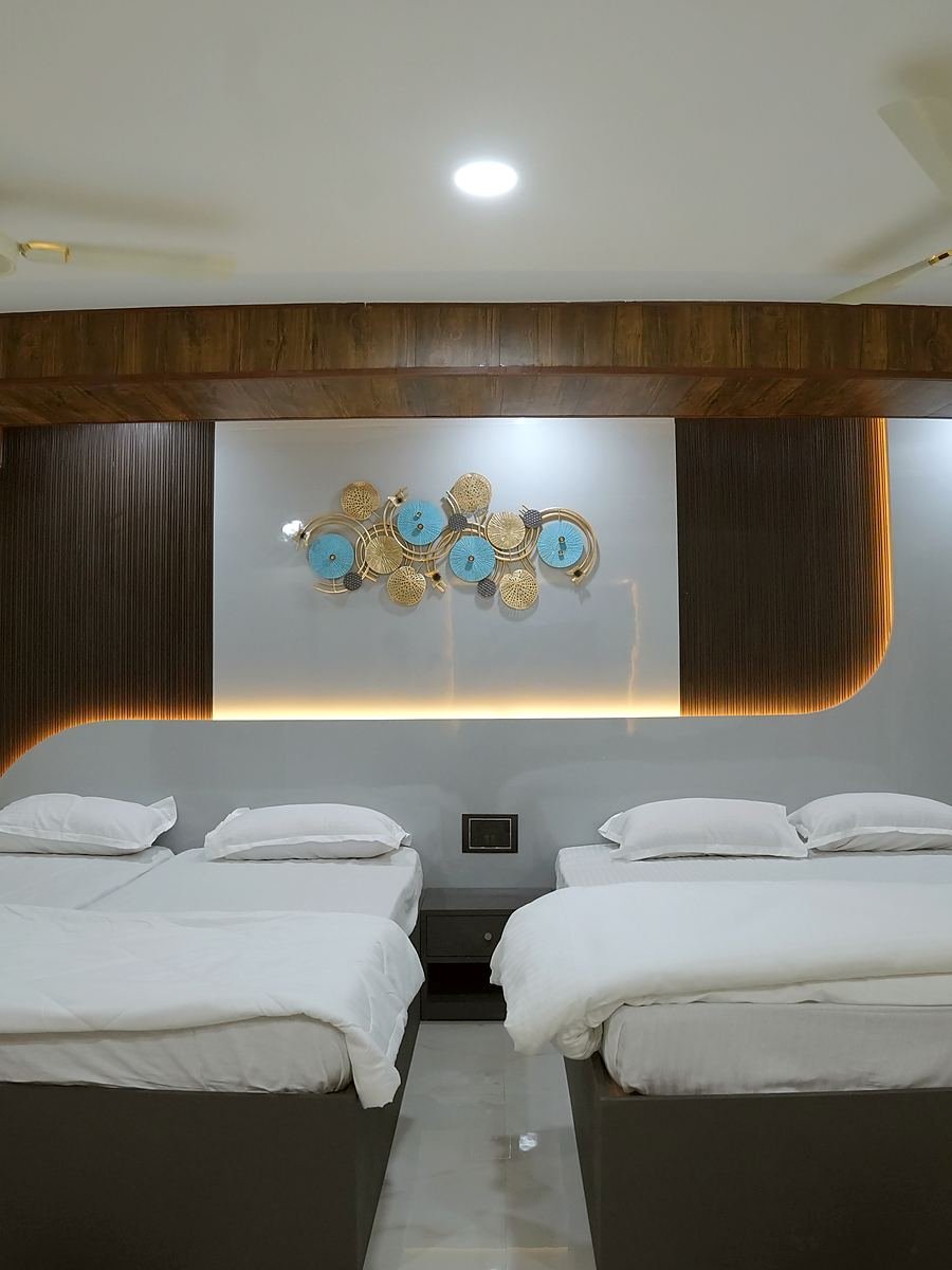 Grand Suite — two king beds below a sculptural feature wall